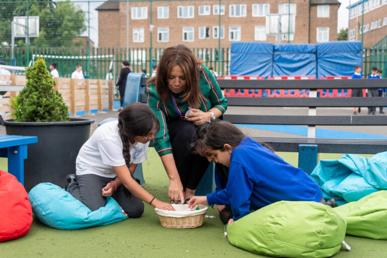 a picture of students and a teacher in the playground