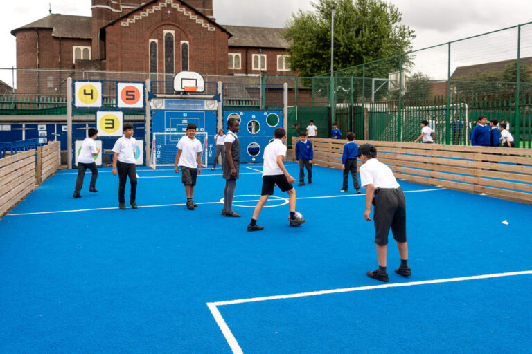 a picture of students playing on the astroturf