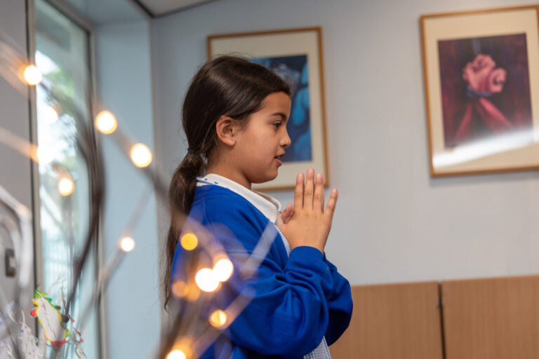 a close up of a student praying