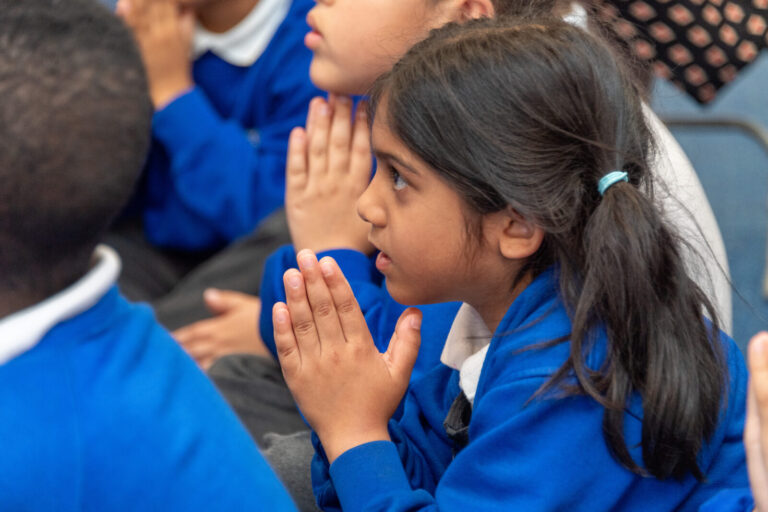 a close up of a student praying