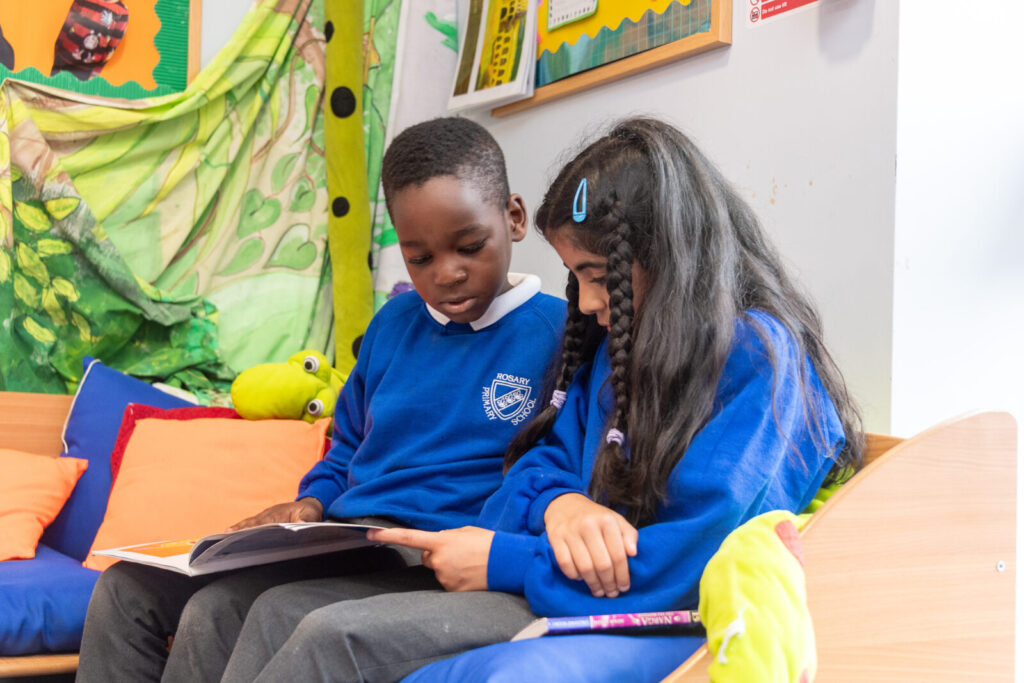 a picture of two students reading a book