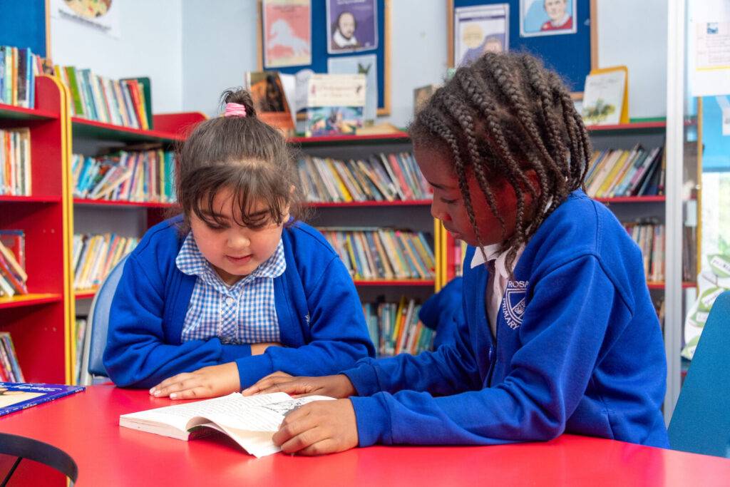 a picture of two students reading a book