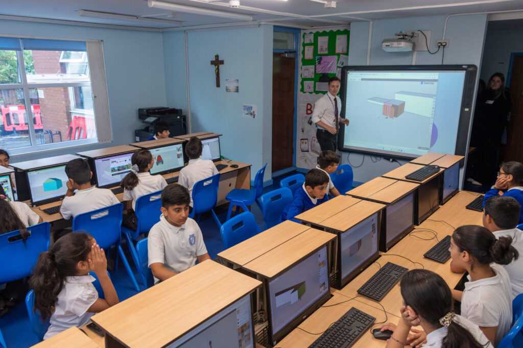 a picture of the teacher showing the work to the class