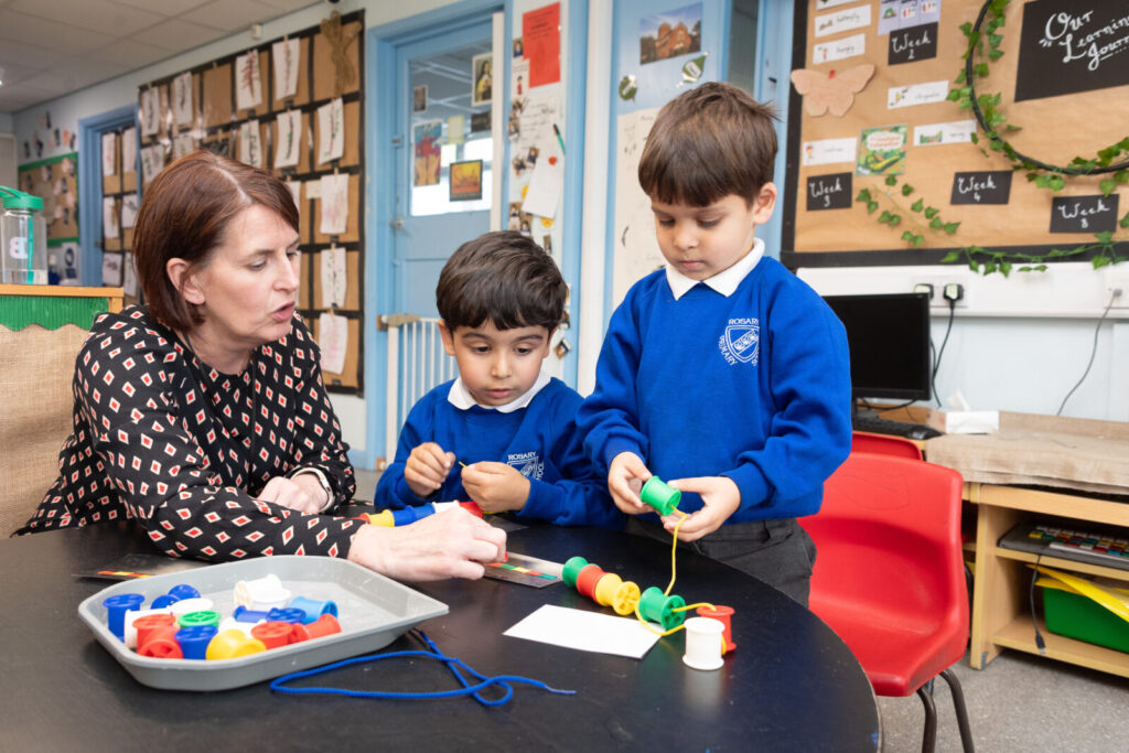 a picture of a teacher helping the students