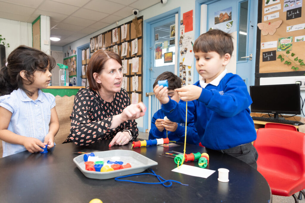 a picture of a teacher helping the students