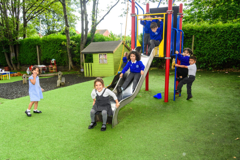 a picture of students playing on the slide
