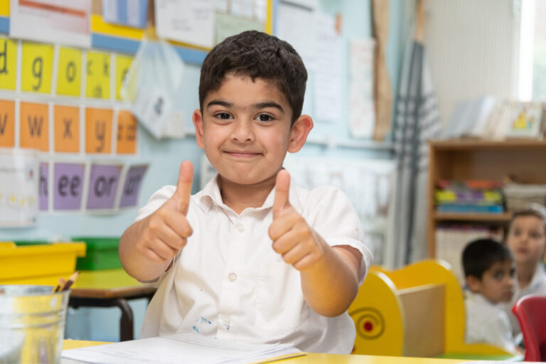 a picture of a student with their thumbs up