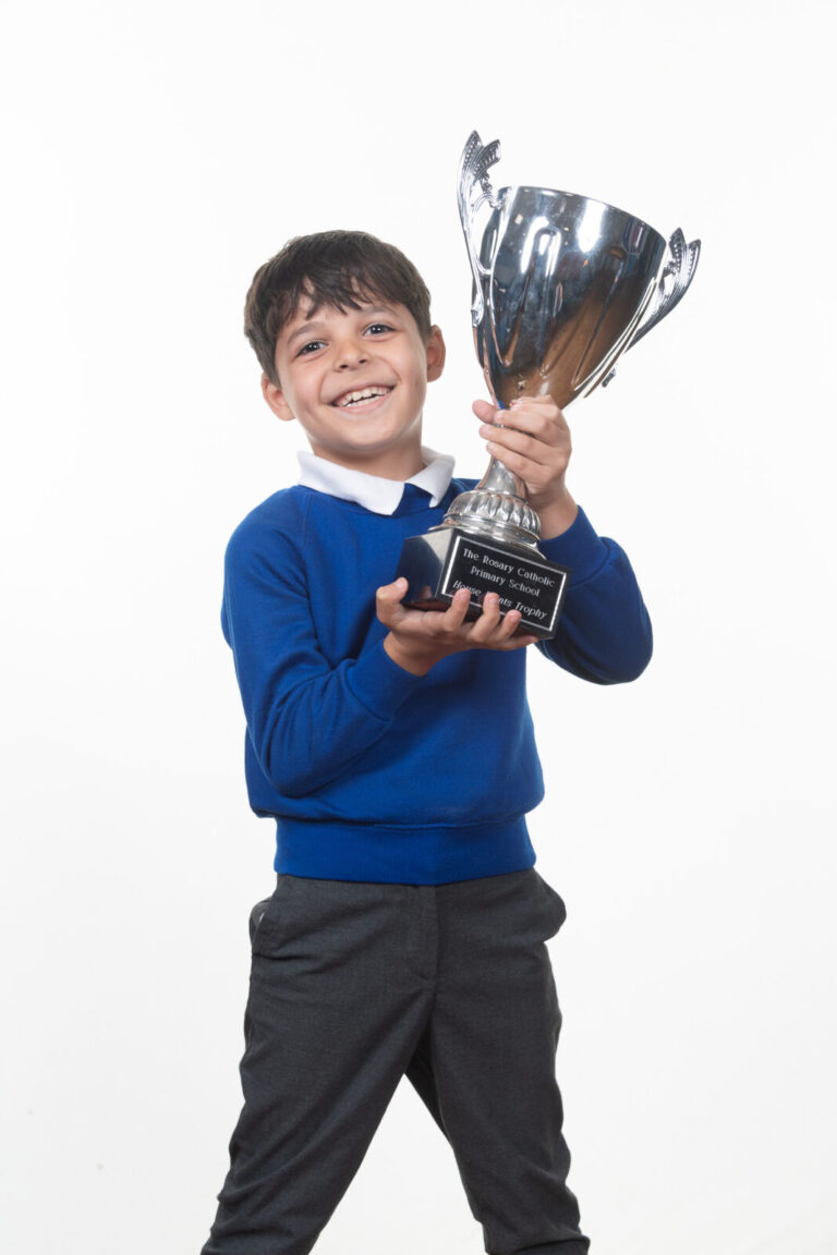 a picture of a student holding a trophy